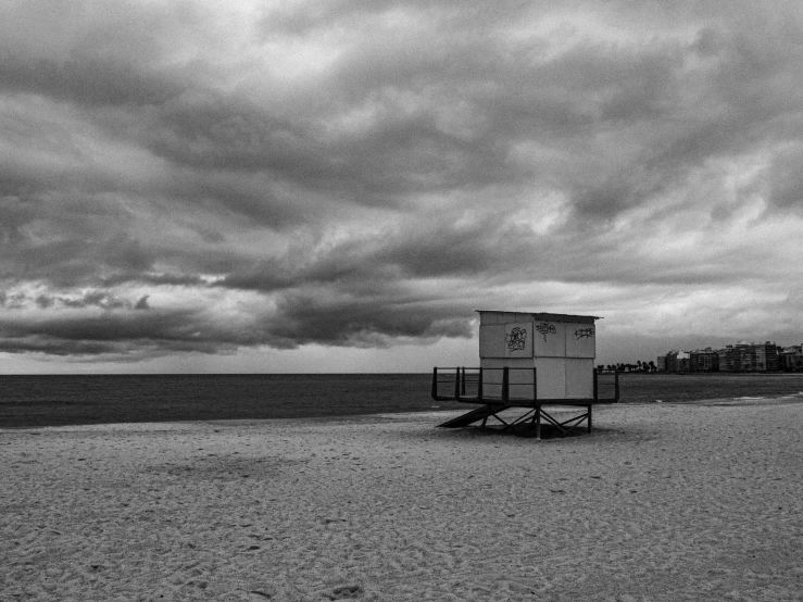 a lifeguard stand on the beach next to the water