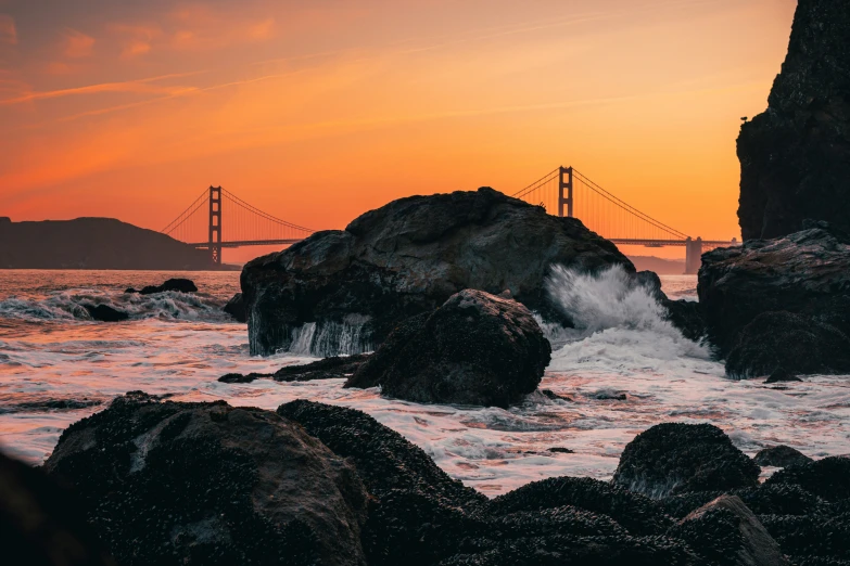 a large body of water next to a suspension bridge