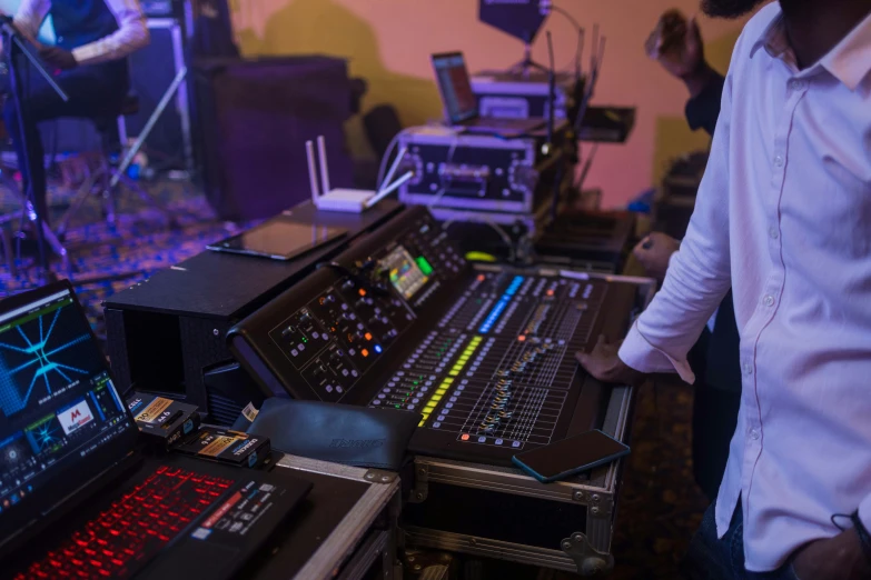 some music mixing equipment and musicians in the background