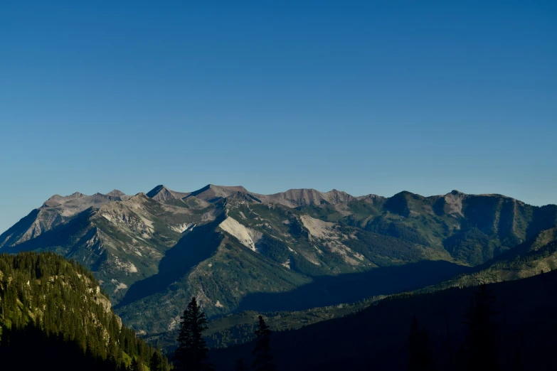 a view of mountains from the top of a hill