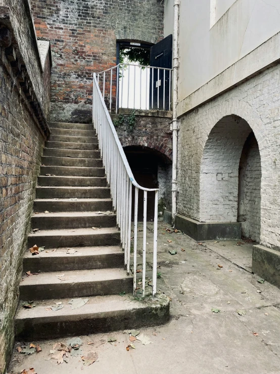 some stairs are next to a brick building