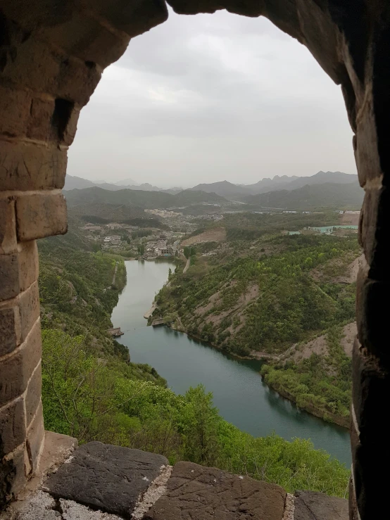 a view looking down on a body of water, land and mountains