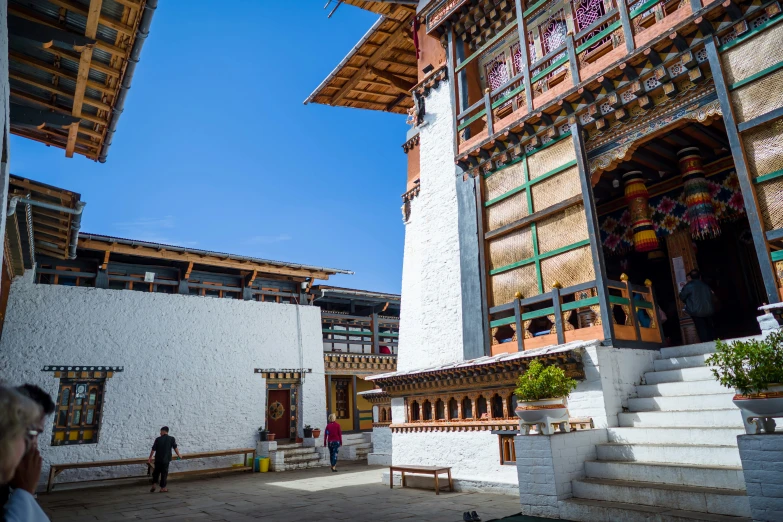 tourists visit a shrine in the middle of a square