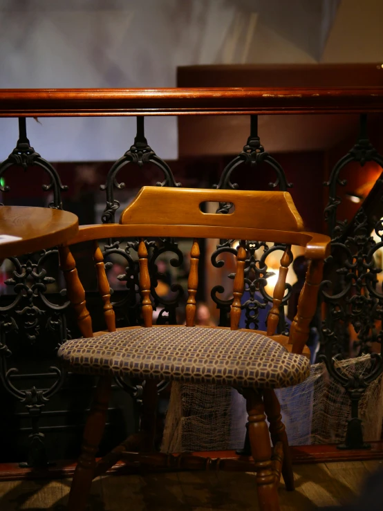 this is an old fashioned rocking chair with a plaid seat pad