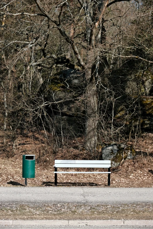 bench sitting on side walk beside a road