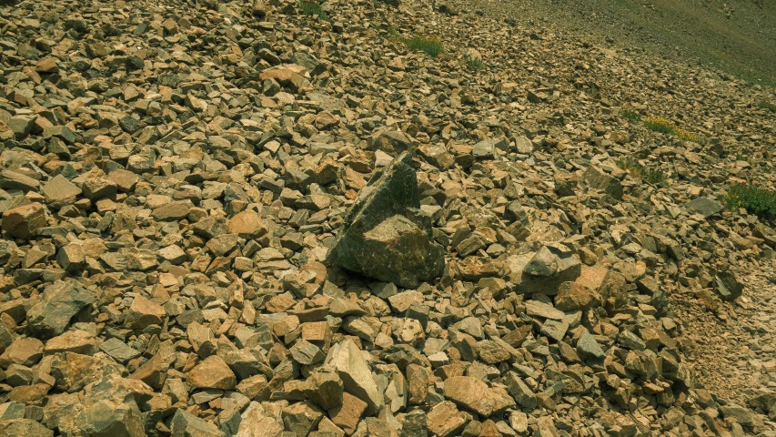 a red car sitting in a gravel road