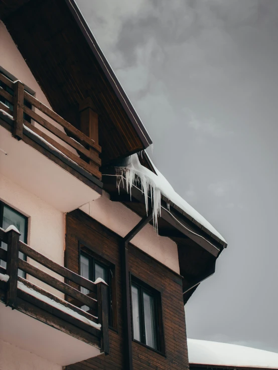 a building with snow and icicles hanging off of it's windows