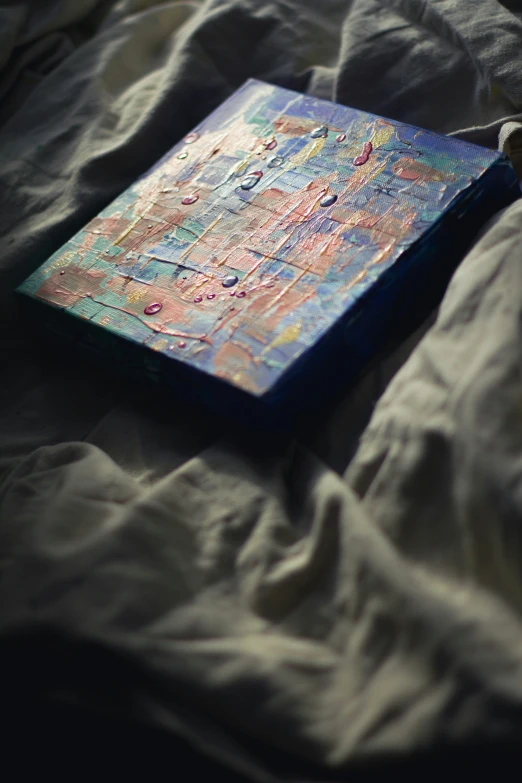 there is a small colorful painting on top of this book