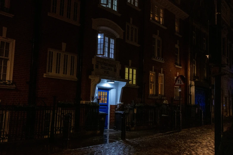 the back of a house at night with light shining on it