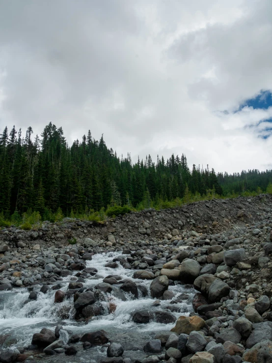 there is a man on a river in the mountains