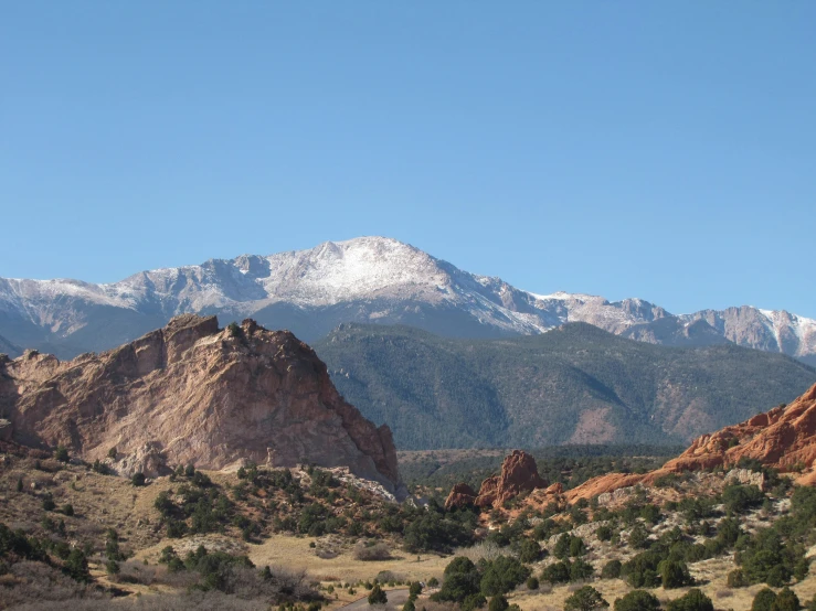 a mountain range in the background with a snow covered mountain