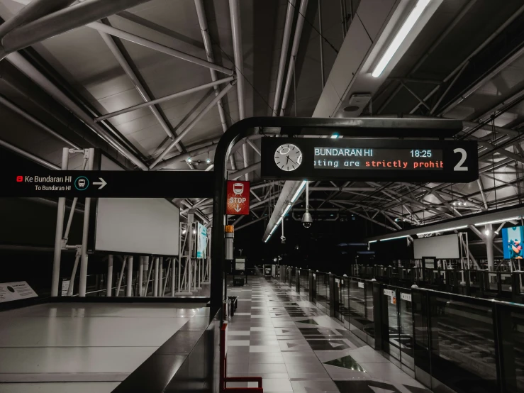 the interior of an airport with a lot of signs