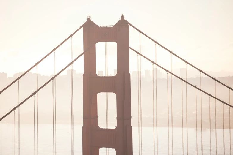 the golden gate bridge is towering over the water