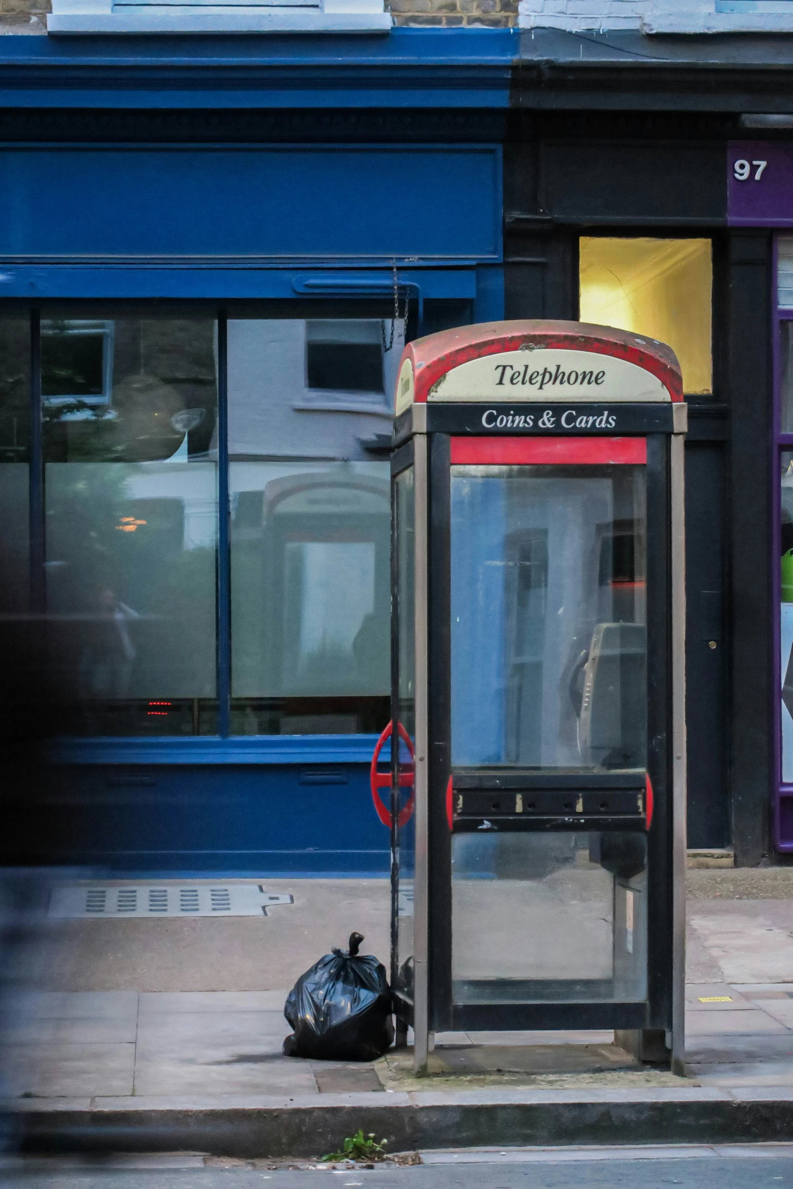 an old newspaper dispenser sitting on the street