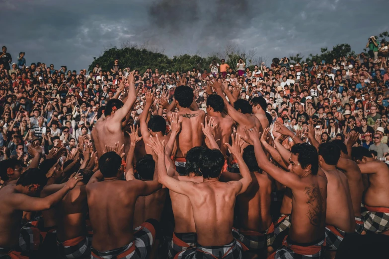 a large group of people in front of a crowd of men