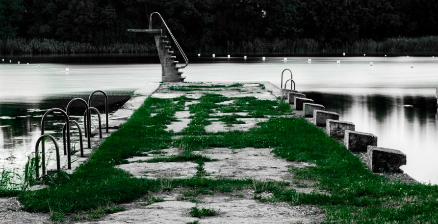 a dock that is sitting on the grass by a lake