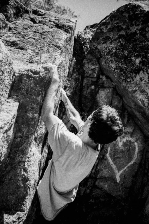 a person climbing up the side of a mountain