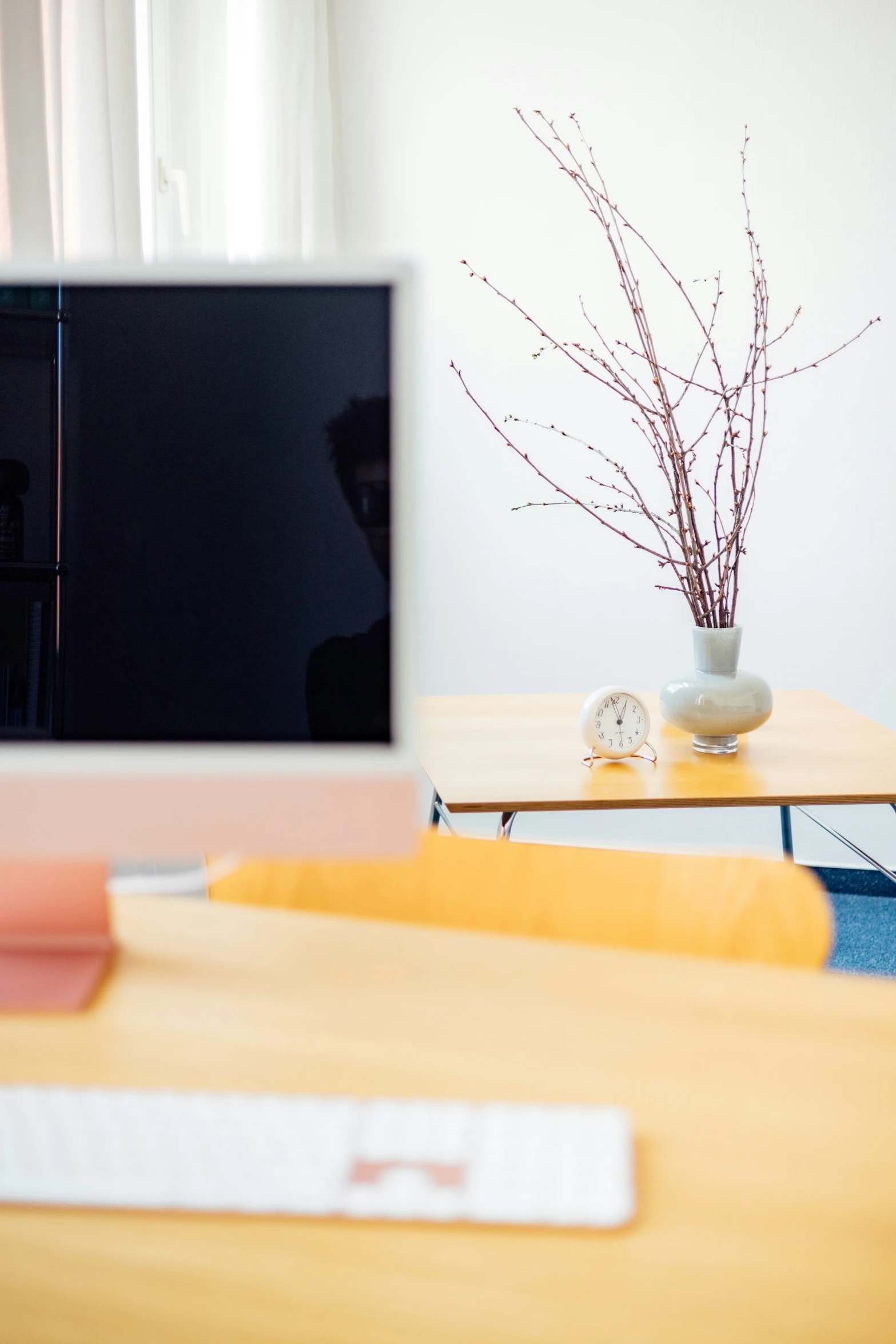 an empty room with a table, tv, and chair