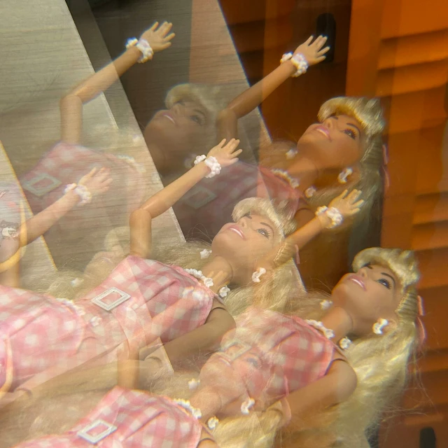 four dolls dressed in plaid looking at soing