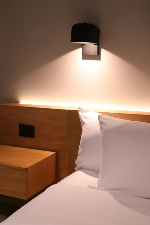 a close up view of a el bed with an empty bedside table