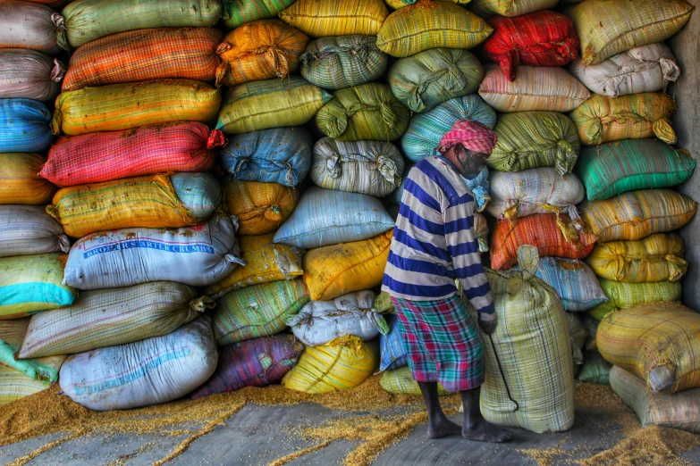 a large group of sacks of different colors sitting in a pile