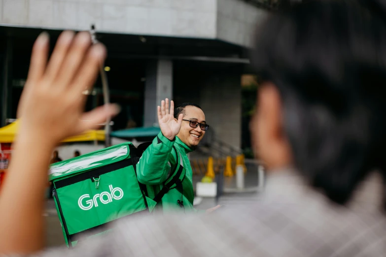 two people are greeting one another with their hand