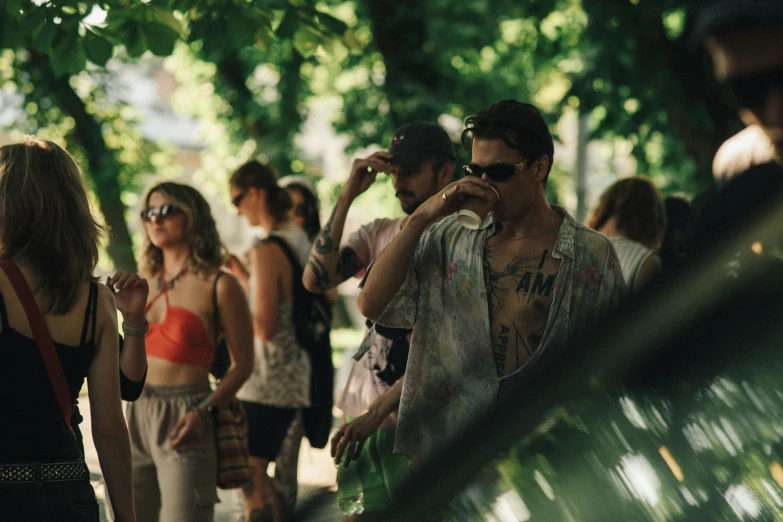 a group of people standing under a shade tree