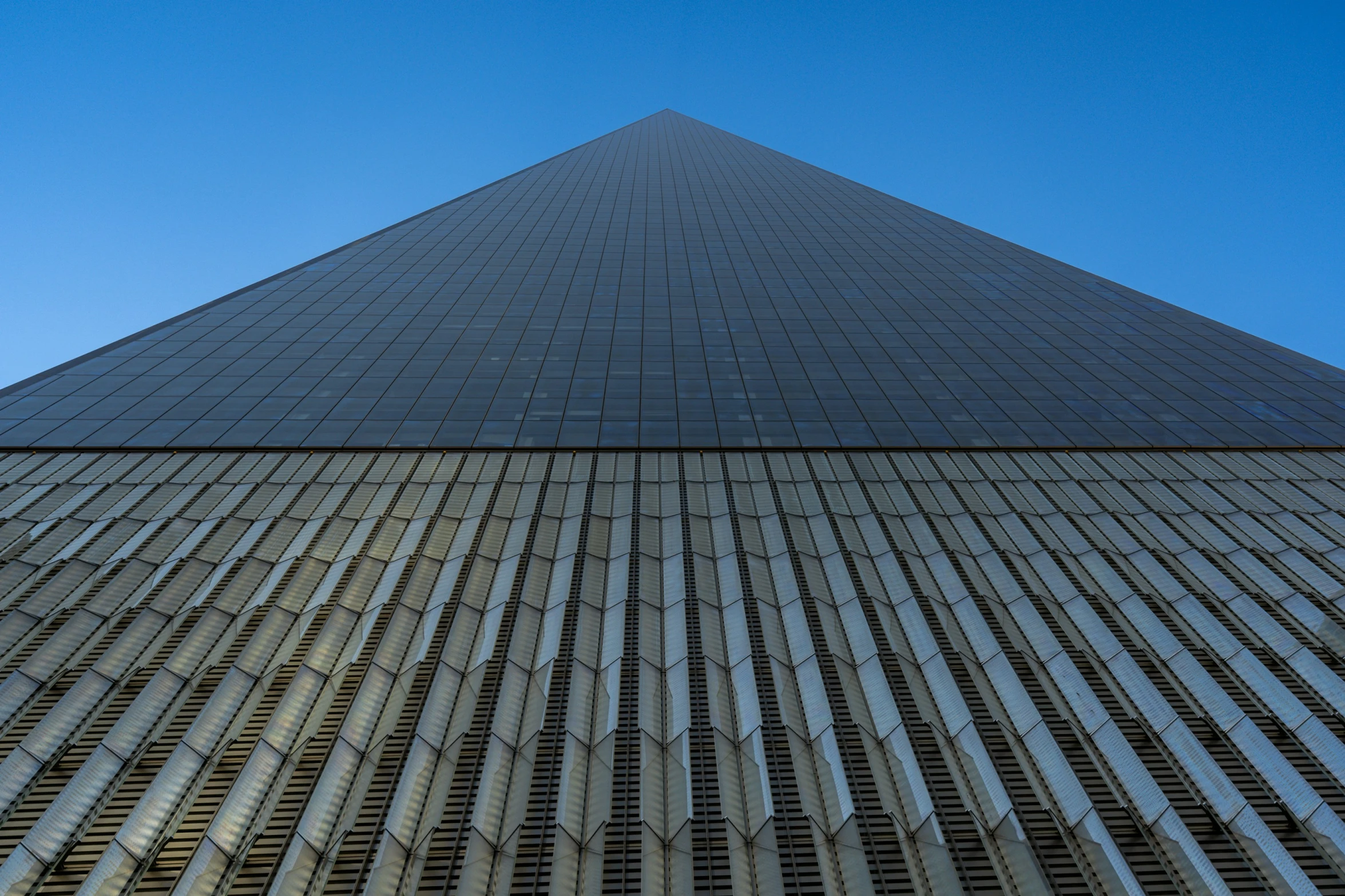 the side of a very tall building with metal bars on it