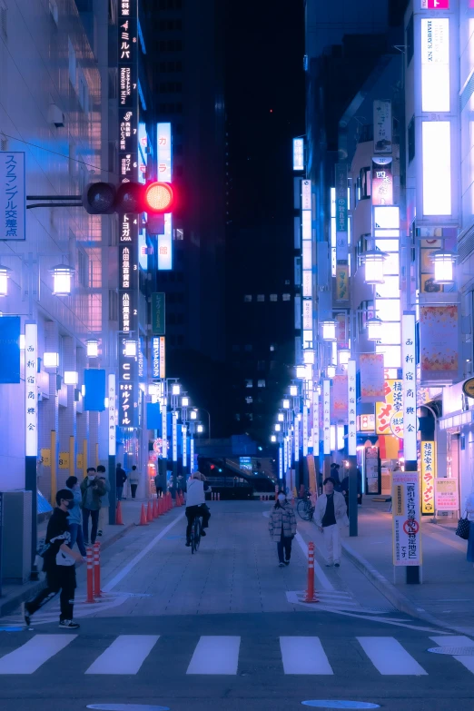 an alley with traffic lights in shinjuju at night