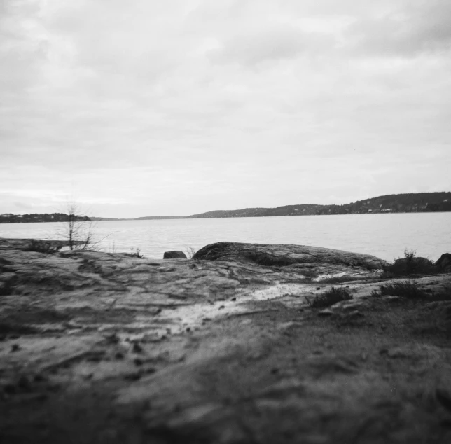 black and white pograph of a cloudy sky over a body of water