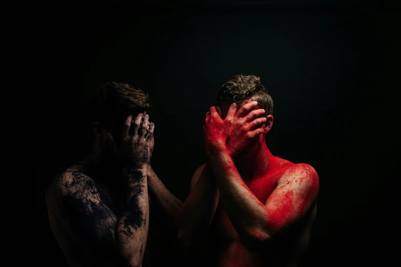 man covering his face with hands, covered in 