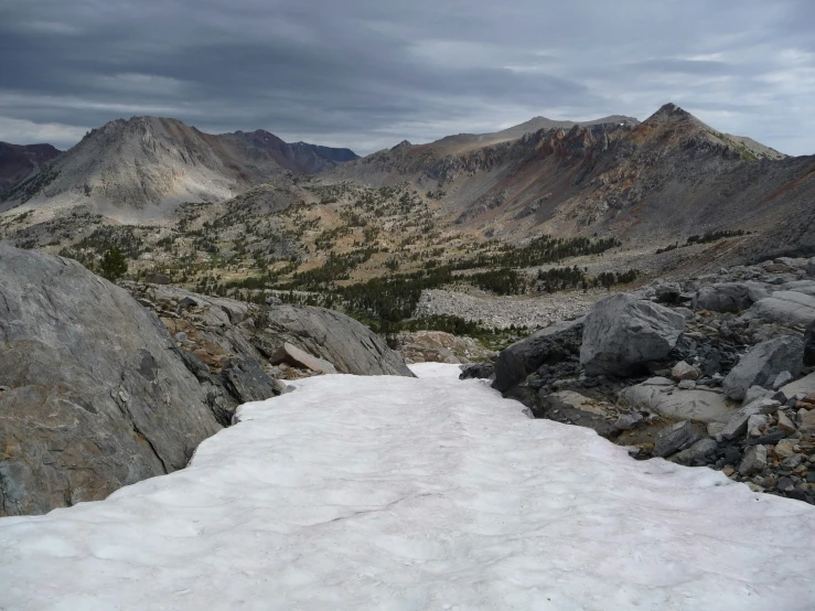 an image of snow mountain with rocks and boulders