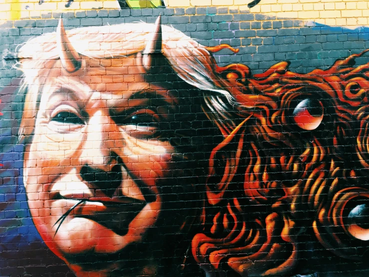 a painted wall of a man with horns in his mouth
