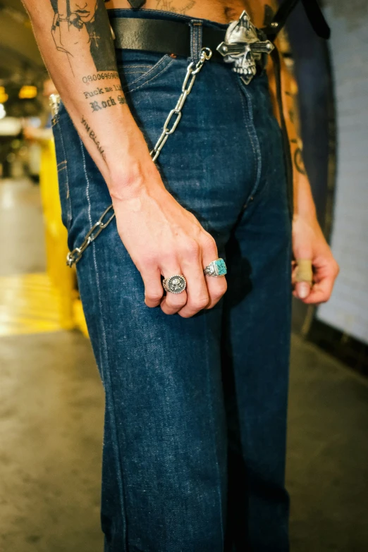 a man with his tattoo on holding a ring