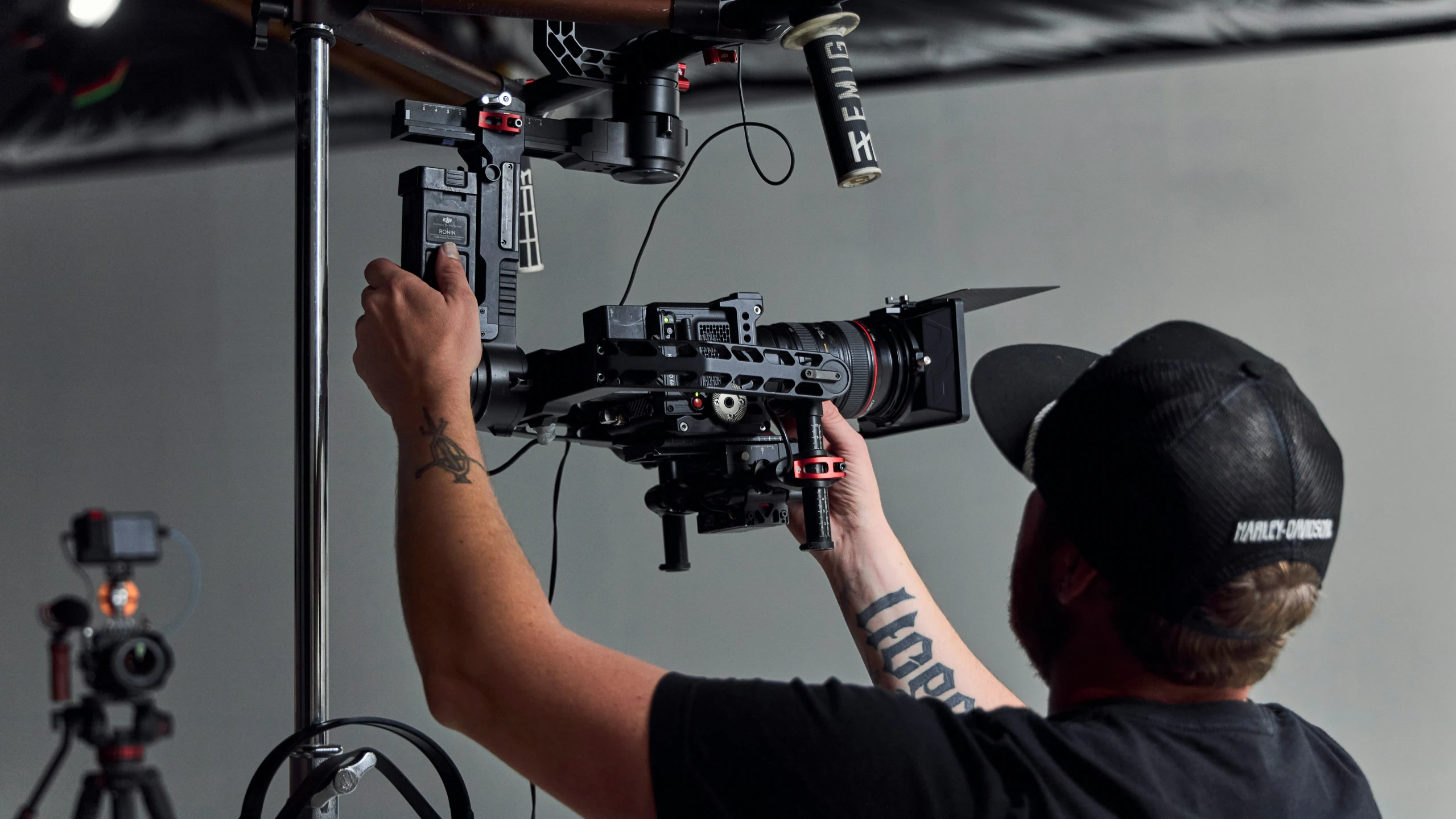 a man working on a camera with a microphone