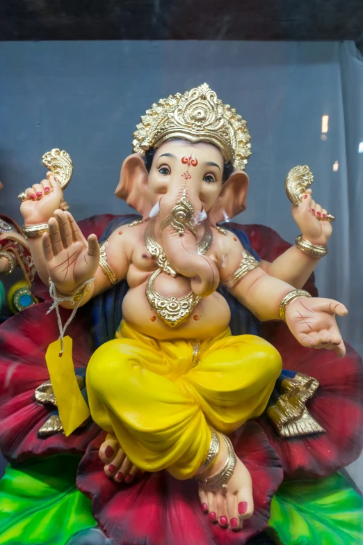 the little ganesha statue is painted bright colors