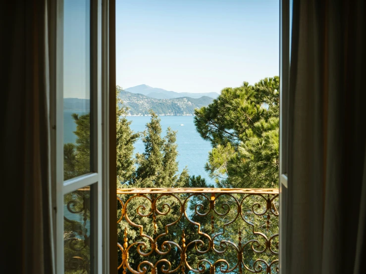 an open window overlooking the lake and mountains