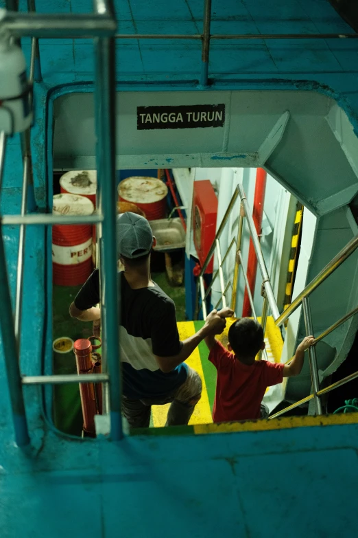 a young child helping an older man to board the train