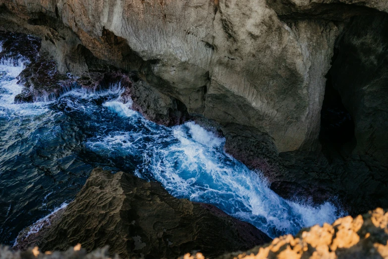 blue waves in between two rocky walls