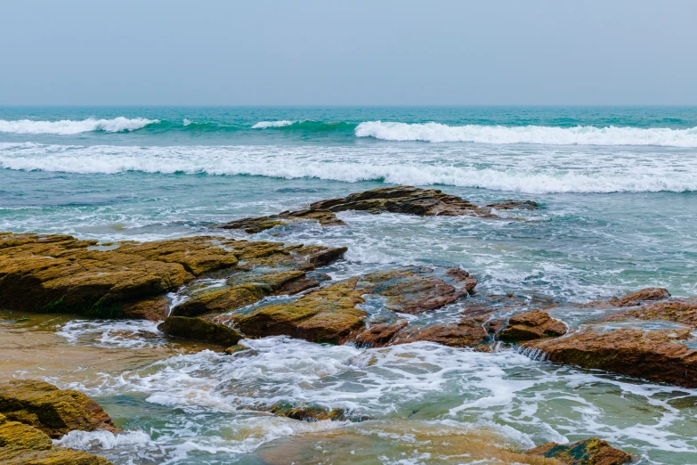 rocks and water at the beach with ocean waves