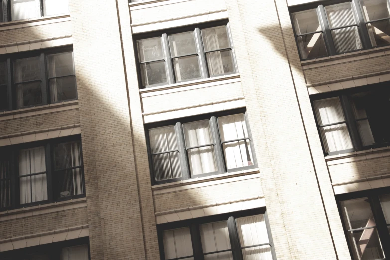 an image of apartment building with windows that are open