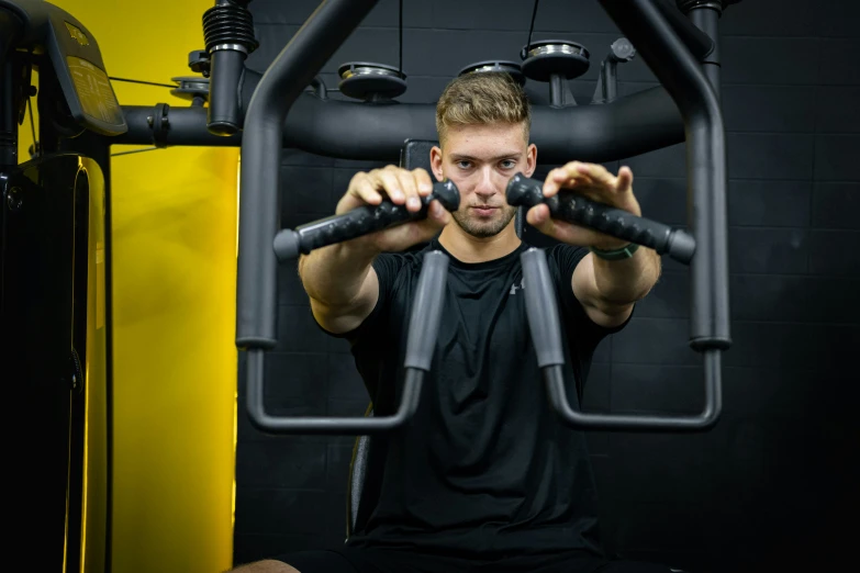 a man sitting in the gym doing exercise