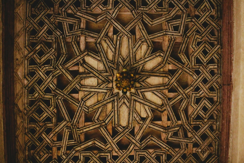 a wooden carving that has a flower and some smaller objects