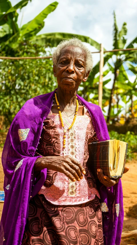 an old woman wearing an elaborate purple outfit