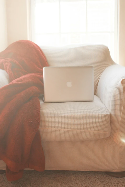 a living room with an apple computer on the arm