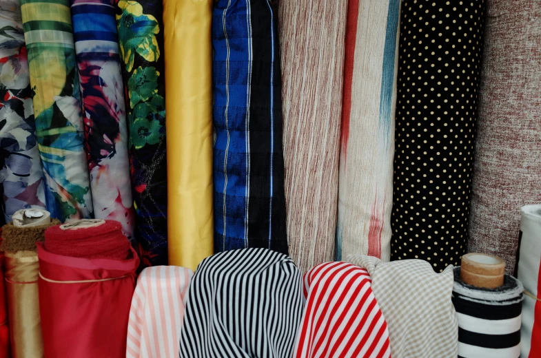 a pile of different colored ties and cloths