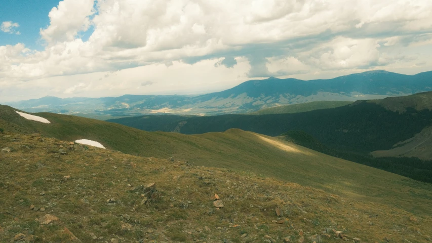 the landscape is full of green hills with mountains