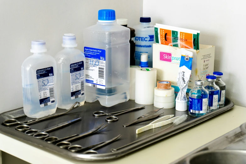 a tray with many bottles of water and cleaning tools