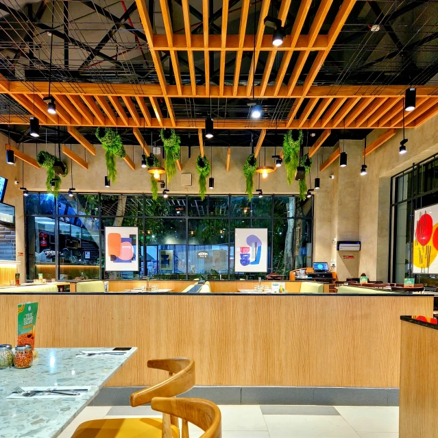 an empty dining room with lots of lights and hanging plants