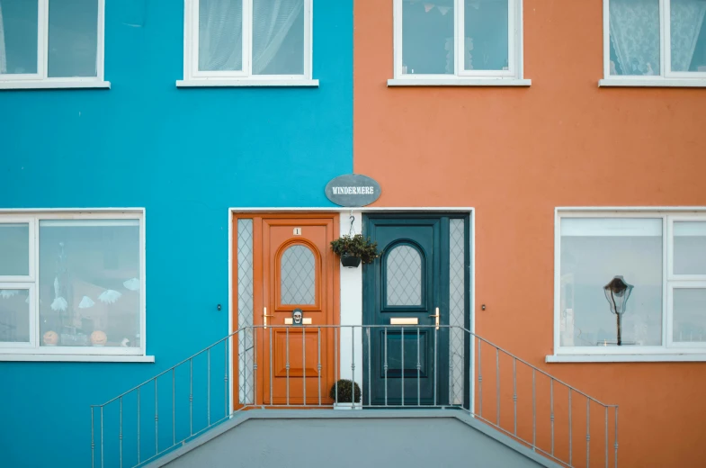 a very tall colorful building with two front doors